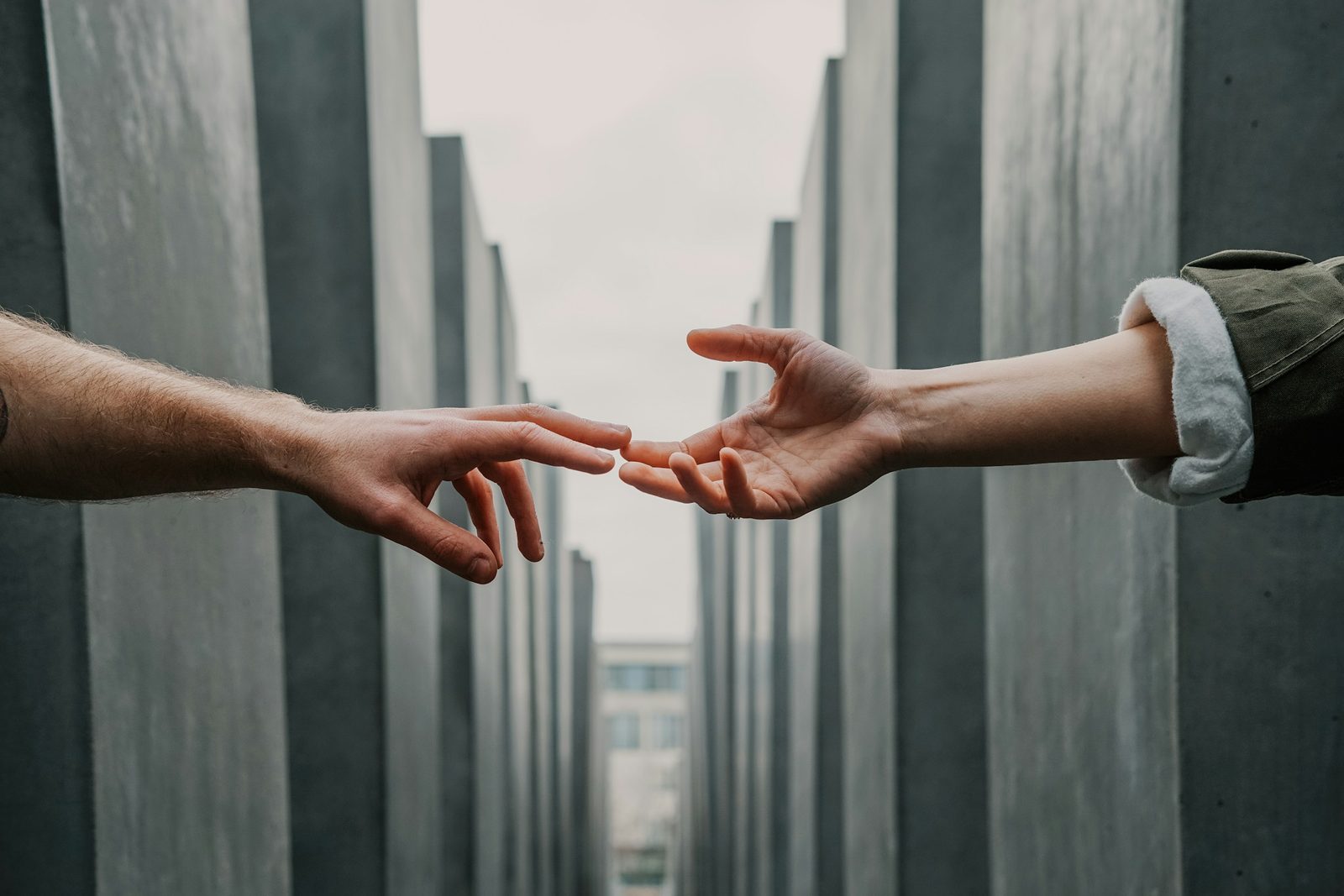 Two hands reaching towards each other
