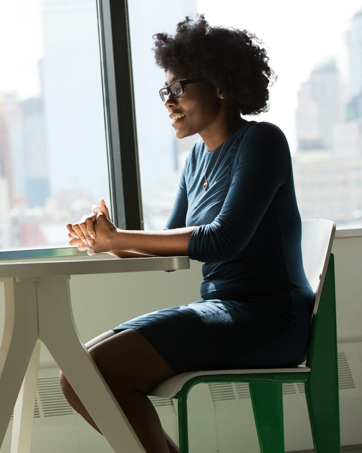 Someone sitting by a window, thinking